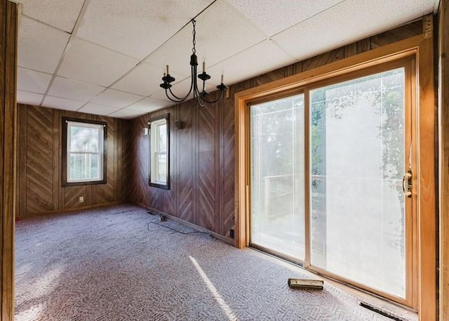 15 Hope Ct, West Warwick, RI 02893 - unfurnished dining area with wooden walls, a drop ceiling, carpet, and a chandelier