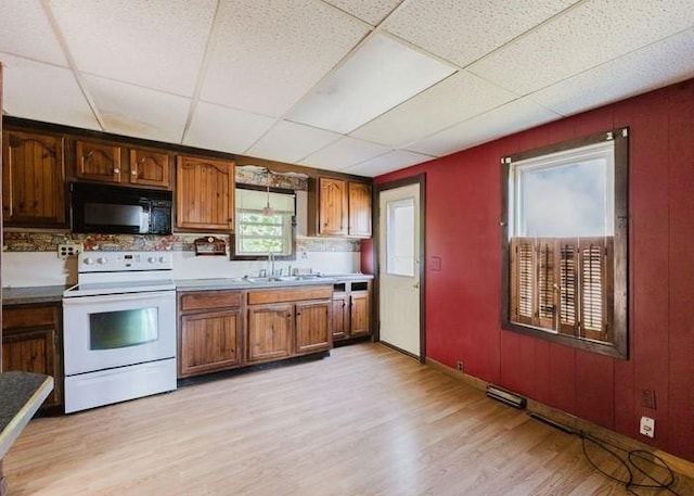 15 Hope Ct, West Warwick, RI 02893 - kitchen featuring black microwave, electric range, light wood finished floors, a drop ceiling, and brown cabinets