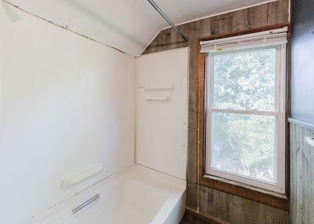 15 Hope Ct, West Warwick, RI 02893 - bathroom with vaulted ceiling, shower / washtub combination, and wooden walls
