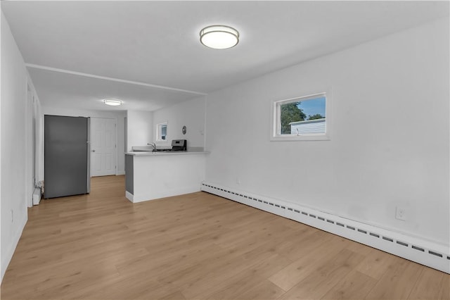 15 Maplewood Ave, Warwick, RI 02889 - unfurnished living room with a baseboard radiator and light wood-style floors