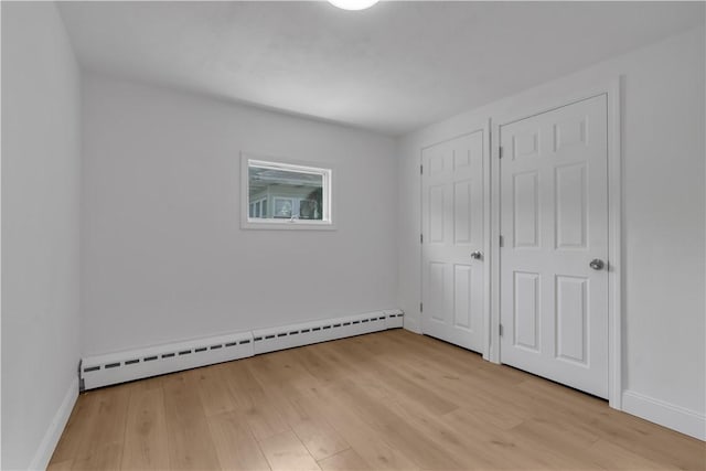 15 Maplewood Ave, Warwick, RI 02889 - unfurnished bedroom featuring a baseboard radiator and light wood-style flooring
