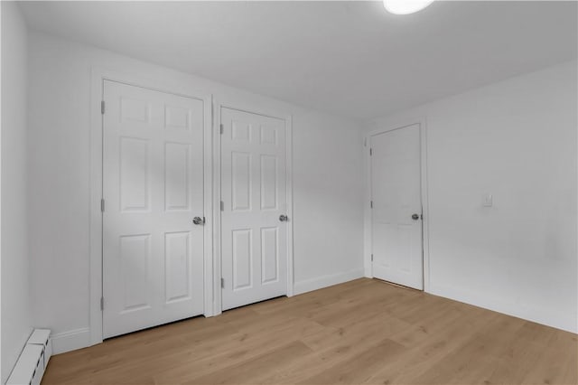 15 Maplewood Ave, Warwick, RI 02889 - unfurnished bedroom with baseboard heating and light wood finished floors