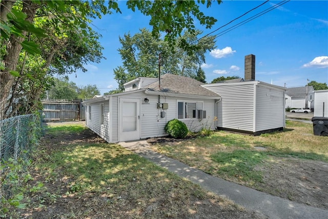15 Maplewood Ave, Warwick, RI 02889 - back of property featuring a chimney and a shingled roof