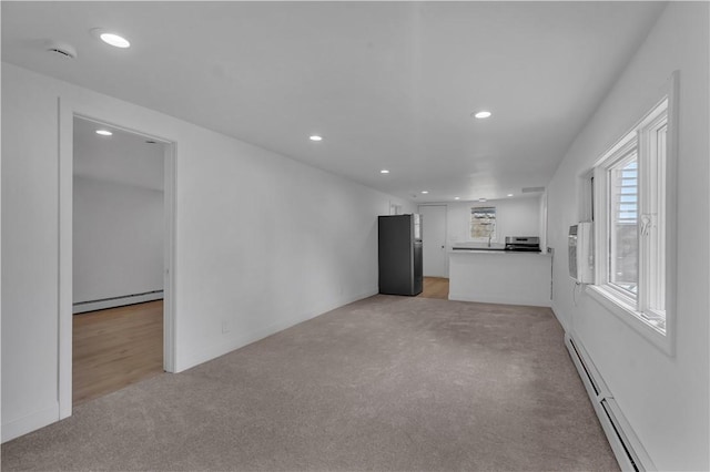 15 Maplewood Ave, Warwick, RI 02889 - unfurnished living room featuring baseboard heating, light colored carpet, and recessed lighting