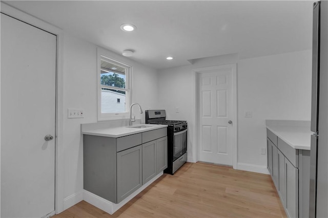 15 Maplewood Ave, Warwick, RI 02889 - kitchen with stainless steel range with gas stovetop, gray cabinetry, light wood-style floors, light countertops, and recessed lighting
