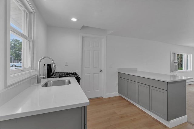15 Maplewood Ave, Warwick, RI 02889 - kitchen featuring gray cabinetry, light countertops, recessed lighting, a peninsula, and light wood-style floors