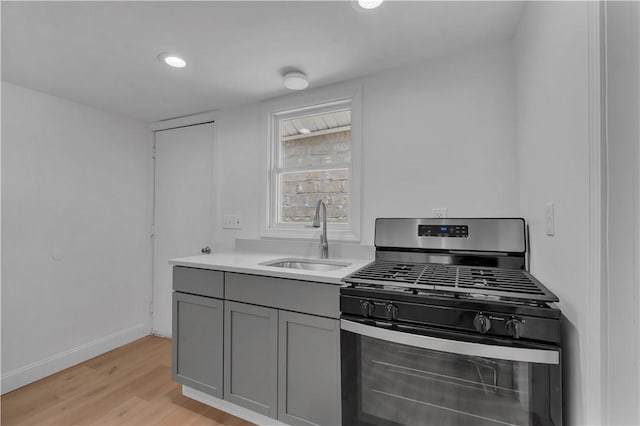 15 Maplewood Ave, Warwick, RI 02889 - kitchen featuring stainless steel gas range, gray cabinetry, light wood-type flooring, light countertops, and recessed lighting
