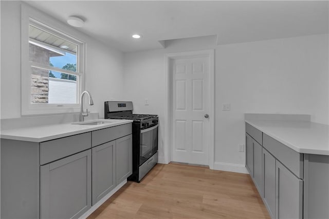 15 Maplewood Ave, Warwick, RI 02889 - kitchen with stainless steel gas range, gray cabinets, light wood-type flooring, light countertops, and recessed lighting