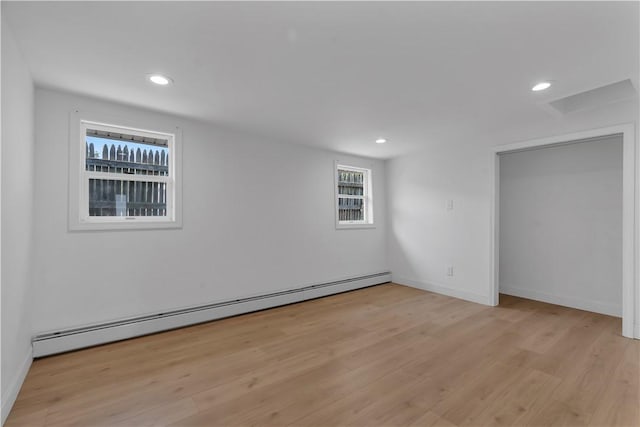 15 Maplewood Ave, Warwick, RI 02889 - unfurnished room featuring a baseboard heating unit, light wood finished floors, and recessed lighting