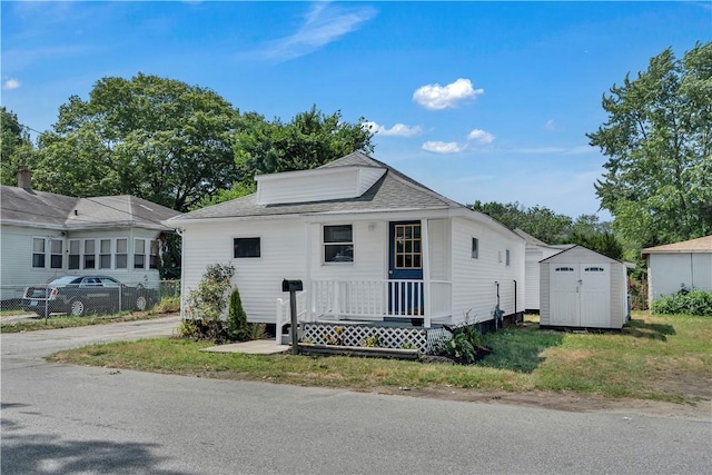 15 Maplewood Ave, Warwick, RI 02889 - view of front facade featuring a storage unit, covered porch, and roof with shingles
