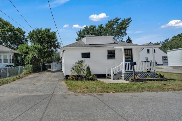 15 Maplewood Ave, Warwick, RI 02889 - view of front facade with concrete driveway and a shingled roof