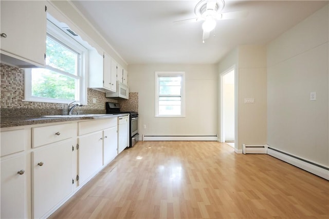 83 Vincent Ave, North Providence, RI 02904 - kitchen featuring baseboard heating, range, healthy amount of natural light, and tasteful backsplash