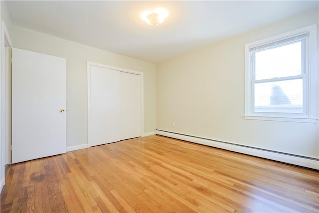 83 Vincent Ave, North Providence, RI 02904 - unfurnished bedroom featuring baseboard heating, light wood finished floors, and a closet