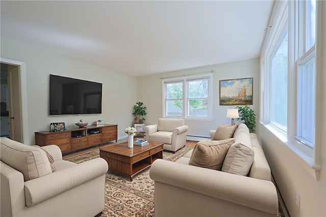 83 Vincent Ave, North Providence, RI 02904 - living area with light wood-style floors and a baseboard radiator