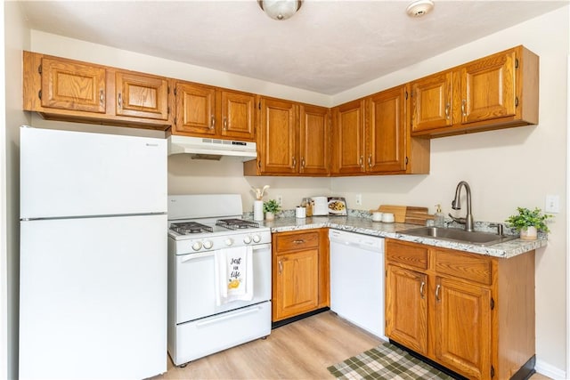 10 E St Unit 207, Cranston, RI 02920 - kitchen with white appliances, under cabinet range hood, light wood-style floors, and brown cabinets