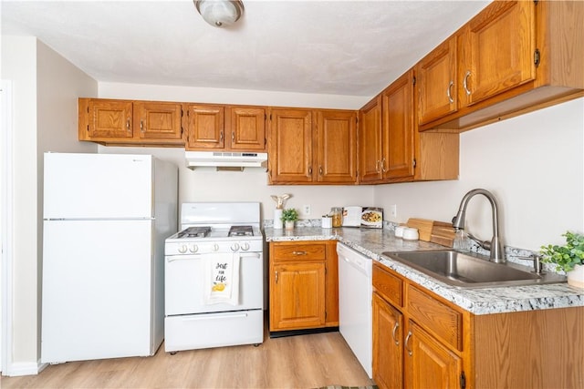 10 E St Unit 207, Cranston, RI 02920 - kitchen with white appliances, under cabinet range hood, light wood-style flooring, and brown cabinets