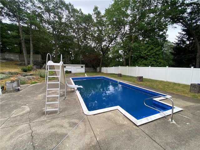 109 Cobble Hill Rd, Lincoln, RI 02865 - view of swimming pool featuring a patio area, a fenced backyard, a water slide, and view of scattered trees