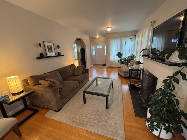 75 Lauriston St, Providence, RI 02906 - living area featuring wood finished floors and a fireplace with raised hearth