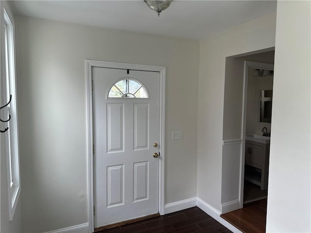 6 Larkspur Rd, Warwick, RI 02886 - entryway with dark wood-type flooring and baseboards