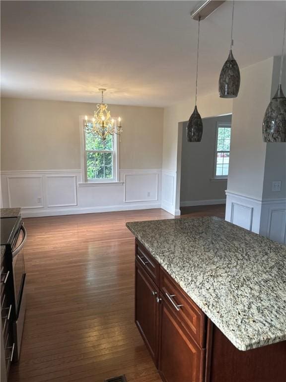 6 Larkspur Rd, Warwick, RI 02886 - kitchen featuring a decorative wall, stainless steel electric range oven, a chandelier, a wainscoted wall, and dark wood-type flooring