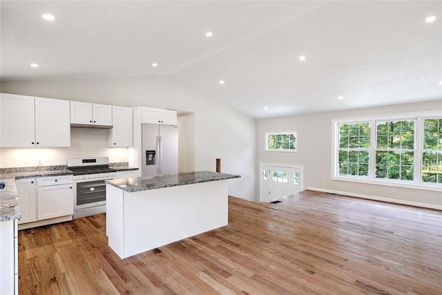 25 Walling Rd, Burrillville, RI 02830 - kitchen featuring fridge with ice dispenser, white stove, light wood-style flooring, a kitchen island, and dark stone countertops