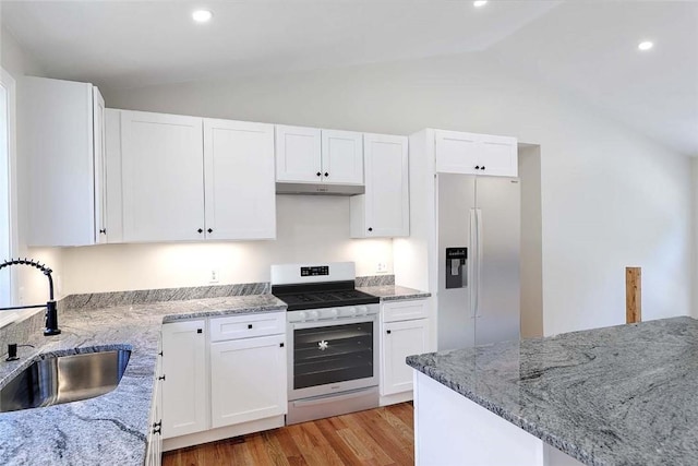 25 Walling Rd, Burrillville, RI 02830 - kitchen featuring fridge with ice dispenser, stainless steel range with gas stovetop, vaulted ceiling, under cabinet range hood, and light stone counters
