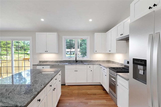 25 Walling Rd, Burrillville, RI 02830 - kitchen with appliances with stainless steel finishes, light wood finished floors, under cabinet range hood, recessed lighting, and light stone counters