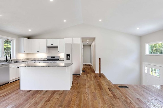 25 Walling Rd, Burrillville, RI 02830 - kitchen with white fridge with ice dispenser, stainless steel dishwasher, range with electric stovetop, light stone countertops, and a kitchen island