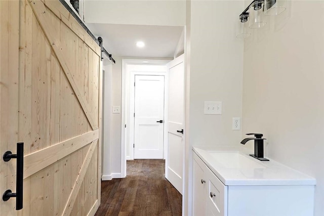 25 Walling Rd, Burrillville, RI 02830 - corridor featuring a barn door, dark wood-style floors, and recessed lighting
