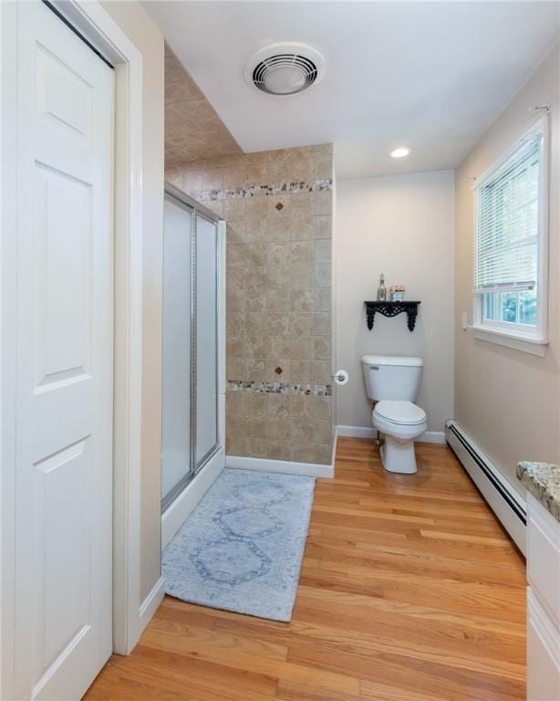 2 Elizabeth Ann Dr, Johnston, RI 02919 - bathroom with a baseboard heating unit, a stall shower, and wood finished floors