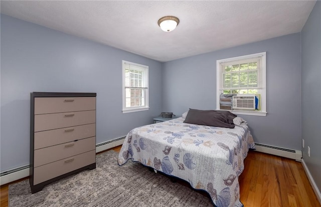 2 Elizabeth Ann Dr, Johnston, RI 02919 - bedroom featuring baseboard heating, wood finished floors, and cooling unit