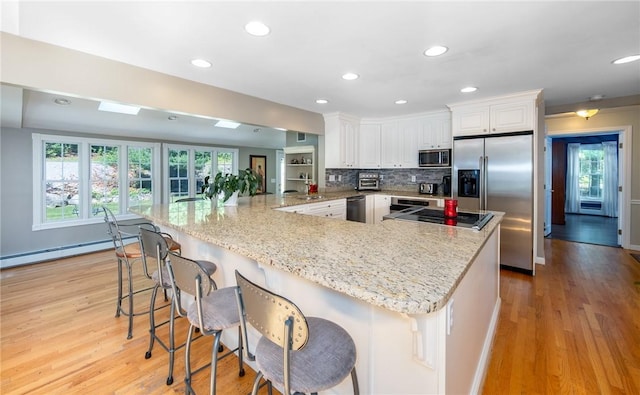 2 Elizabeth Ann Dr, Johnston, RI 02919 - kitchen with appliances with stainless steel finishes, a baseboard radiator, healthy amount of natural light, white cabinets, and recessed lighting