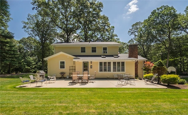 2 Elizabeth Ann Dr, Johnston, RI 02919 - back of property with a patio area, a chimney, and a yard