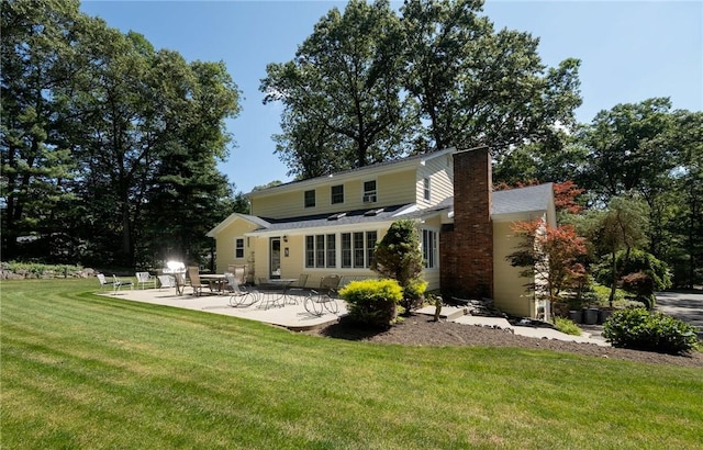 2 Elizabeth Ann Dr, Johnston, RI 02919 - rear view of house with a patio, a yard, and a chimney