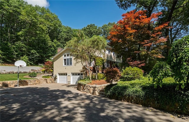 2 Elizabeth Ann Dr, Johnston, RI 02919 - view of side of property featuring a garage, driveway, and a chimney