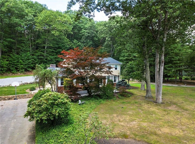 2 Elizabeth Ann Dr, Johnston, RI 02919 - view of home's exterior with a lawn, a wooded view, and a chimney