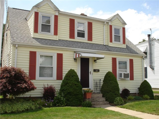 115 Slater Park Ave, Pawtucket, RI 02861 - view of front of home with cooling unit, a shingled roof, and a front yard