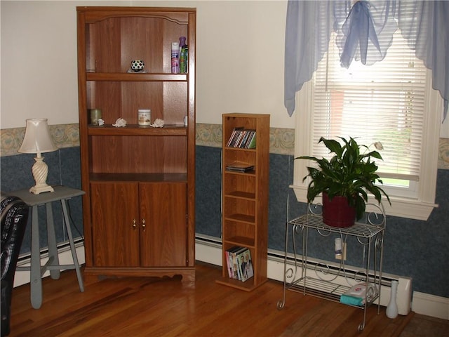 115 Slater Park Ave, Pawtucket, RI 02861 - dining space featuring a baseboard heating unit, wood finished floors, wallpapered walls, and wainscoting