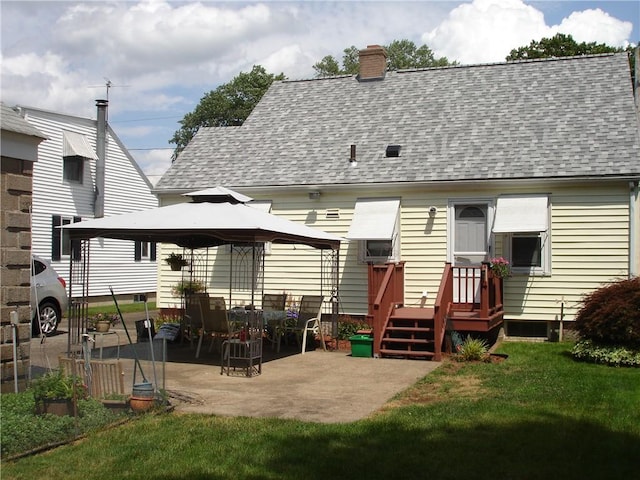 115 Slater Park Ave, Pawtucket, RI 02861 - rear view of property featuring a shingled roof, a gazebo, a chimney, a yard, and a patio area
