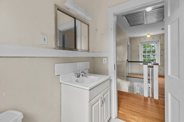 189 Butler Ave, Providence, RI 02906 - half bathroom featuring vanity and wood finished floors