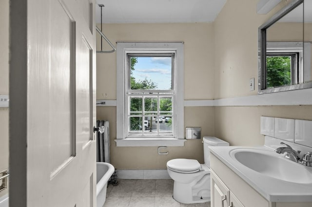 189 Butler Ave, Providence, RI 02906 - full bath with a freestanding tub, healthy amount of natural light, vanity, and tile patterned floors