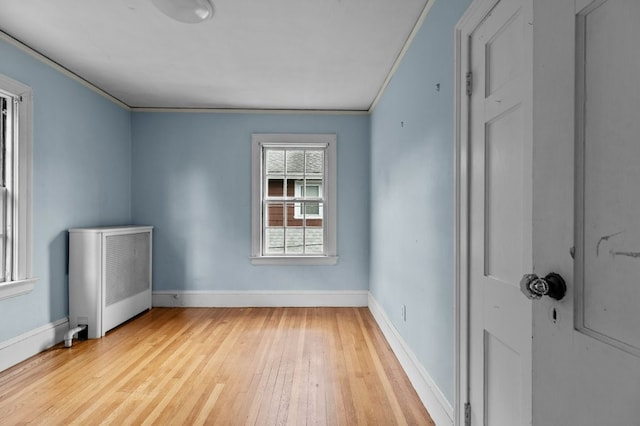 189 Butler Ave, Providence, RI 02906 - spare room with radiator heating unit, wood-type flooring, and crown molding