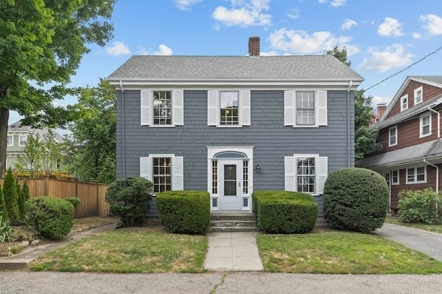 189 Butler Ave, Providence, RI 02906 - colonial-style house with a chimney, roof with shingles, and entry steps