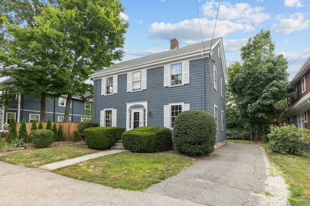 189 Butler Ave, Providence, RI 02906 - colonial inspired home featuring a chimney and roof with shingles