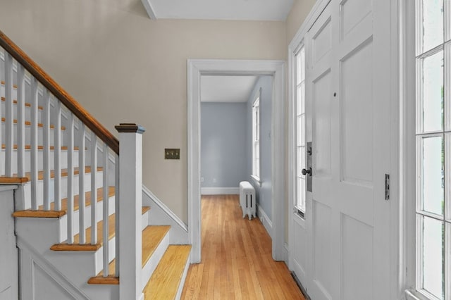 189 Butler Ave, Providence, RI 02906 - foyer with radiator, light wood finished floors, and stairs