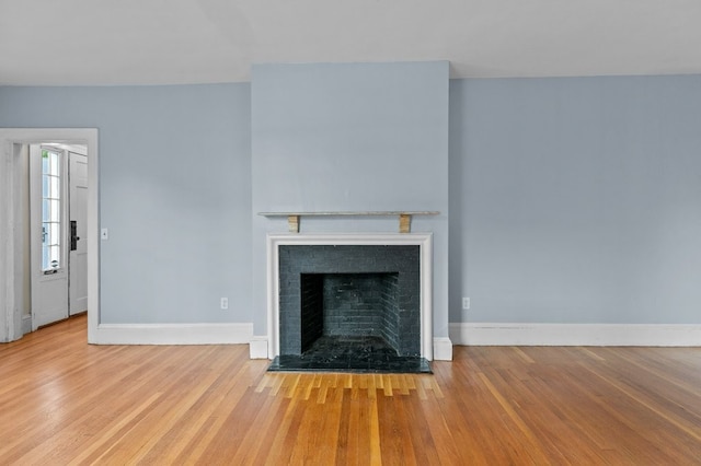 189 Butler Ave, Providence, RI 02906 - unfurnished living room with wood finished floors and a fireplace