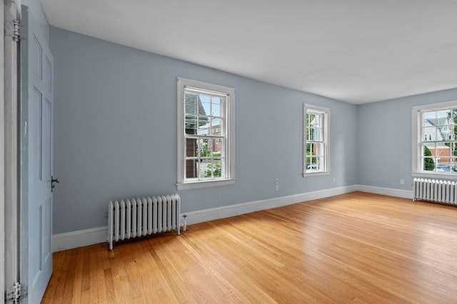 189 Butler Ave, Providence, RI 02906 - unfurnished room with radiator heating unit and light wood-style flooring