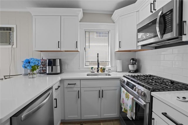 12 Elmore Ave, North Providence, RI 02911 - kitchen featuring stainless steel appliances, backsplash, light countertops, and white cabinets