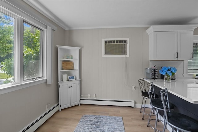 12 Elmore Ave, North Providence, RI 02911 - office with baseboard heating, light wood-style flooring, and a wall unit AC