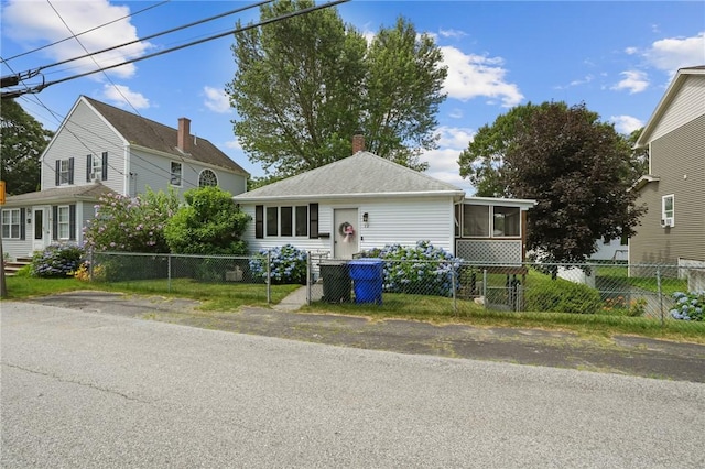 12 Elmore Ave, North Providence, RI 02911 - view of front of property with a chimney and a sunroom